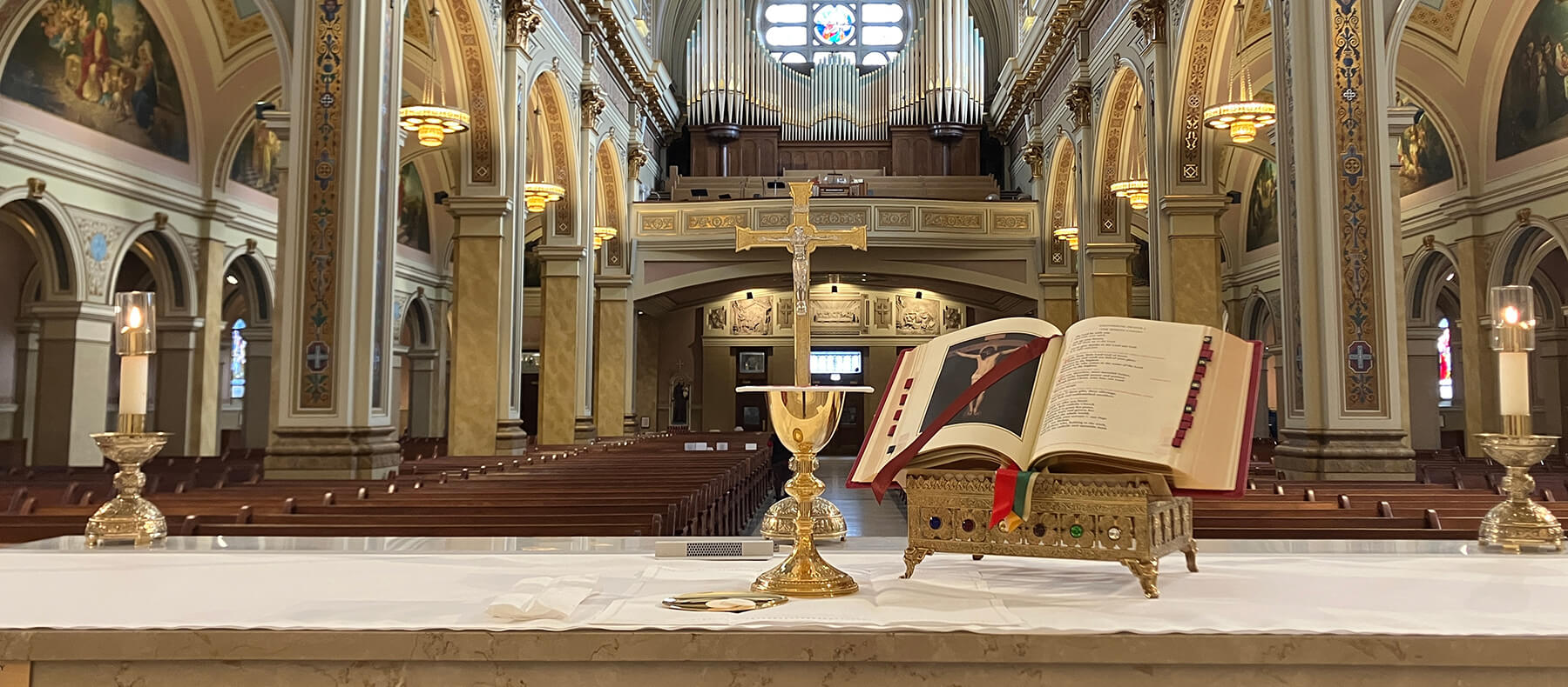 Photo of the inside of a church with a view behind the alter with a Roman Missal from MTF opened.